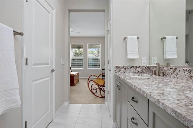 bathroom featuring ceiling fan and vanity