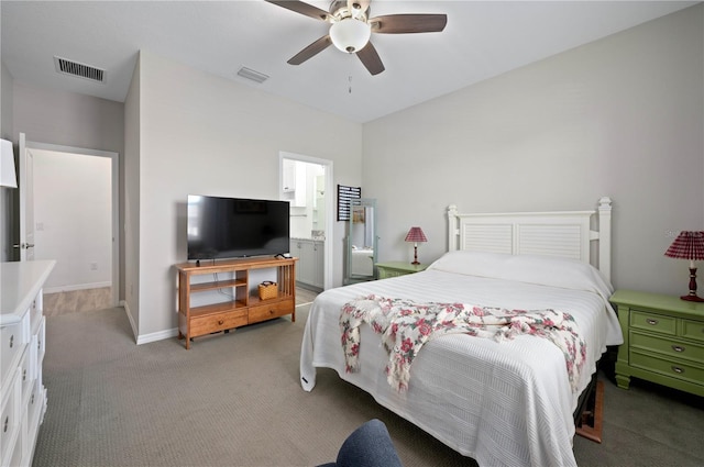 bedroom featuring ceiling fan, ensuite bathroom, and light carpet