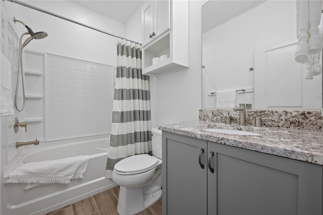 full bathroom featuring vanity, toilet, and shower / bath combo with shower curtain