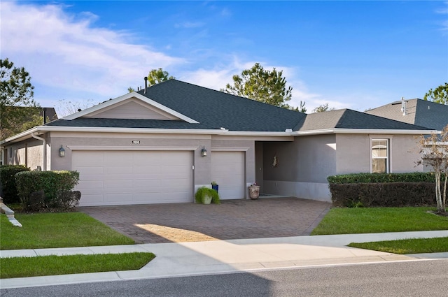 single story home featuring a garage and a front yard