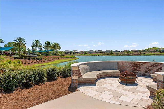 view of patio / terrace featuring a water view and an outdoor fire pit