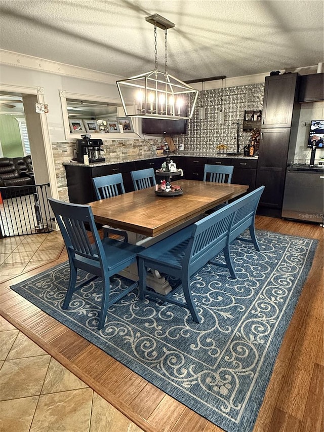 dining space featuring a textured ceiling and an inviting chandelier