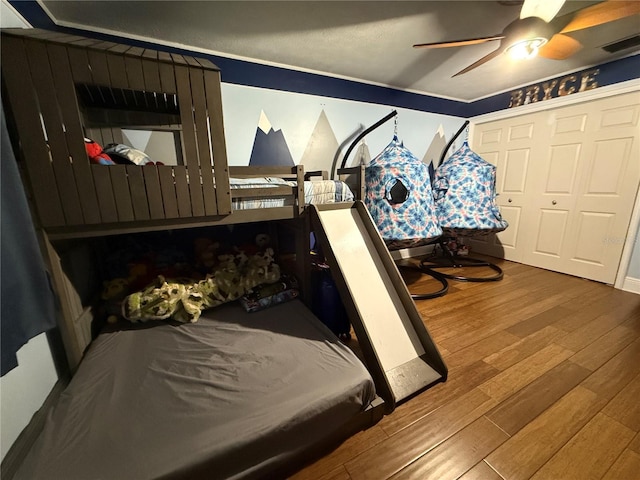 bedroom featuring a closet, hardwood / wood-style flooring, and ceiling fan