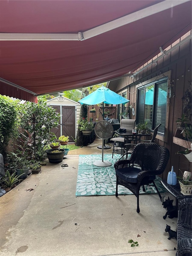 view of patio featuring a storage unit