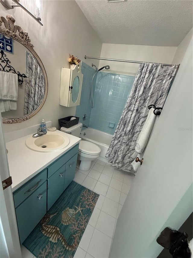 full bathroom featuring shower / tub combo with curtain, tile patterned flooring, vanity, toilet, and a textured ceiling