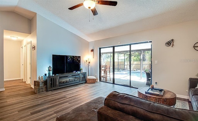 living room with wood-type flooring, a textured ceiling, vaulted ceiling, and ceiling fan