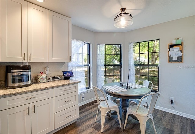 dining space featuring dark hardwood / wood-style flooring and plenty of natural light