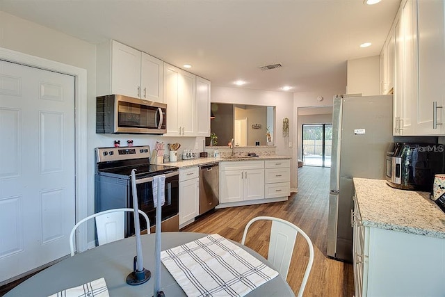 kitchen featuring white cabinetry, light hardwood / wood-style flooring, stainless steel appliances, and sink