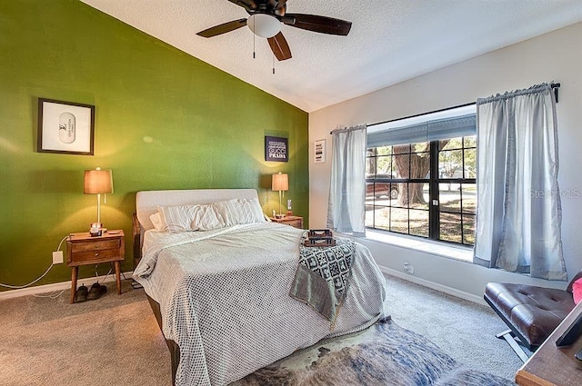 carpeted bedroom featuring a textured ceiling, ceiling fan, and lofted ceiling