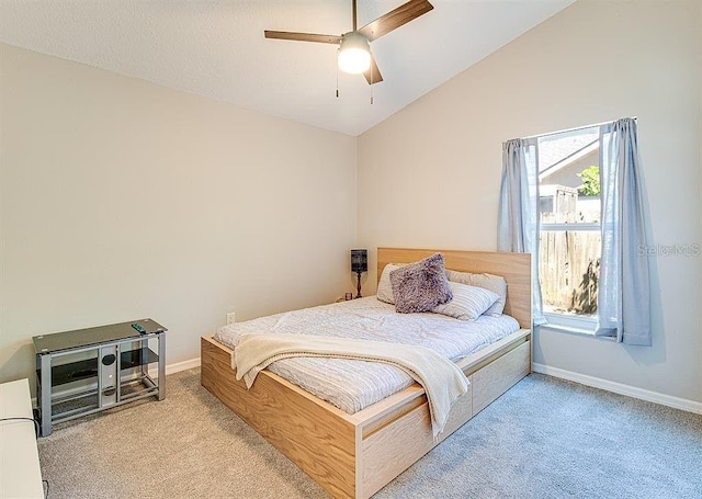 bedroom with light carpet, ceiling fan, and lofted ceiling