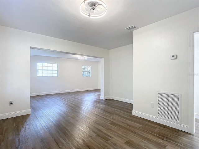 unfurnished room featuring dark wood-type flooring