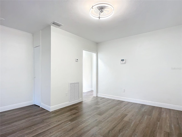 unfurnished room featuring dark hardwood / wood-style flooring