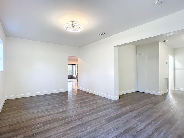 spare room with dark hardwood / wood-style flooring