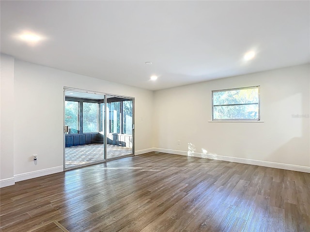 unfurnished room with wood-type flooring