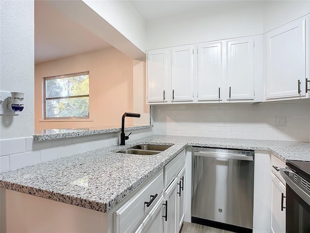 kitchen featuring kitchen peninsula, stainless steel appliances, white cabinetry, and sink