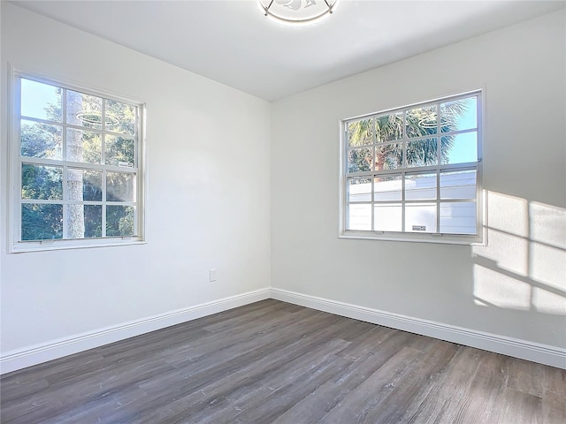 spare room with dark hardwood / wood-style flooring