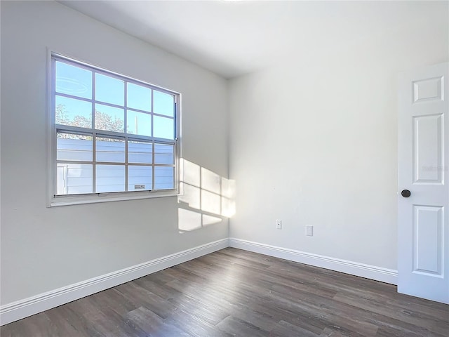 empty room featuring dark hardwood / wood-style flooring