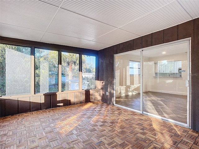 unfurnished sunroom featuring a healthy amount of sunlight