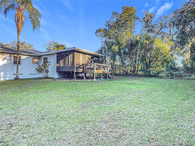 view of yard with a wooden deck and a sunroom