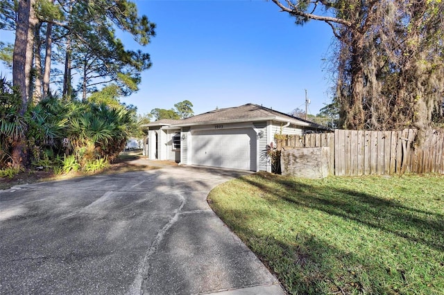 view of front of property featuring a garage and a front lawn