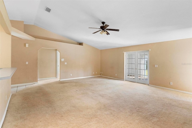 unfurnished living room featuring ceiling fan, french doors, light colored carpet, and lofted ceiling