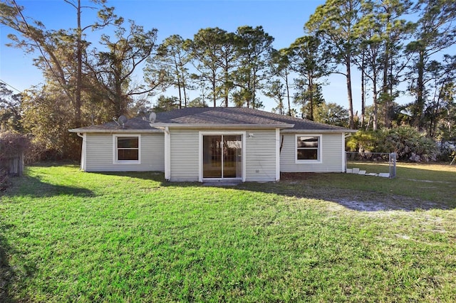 back of house with a lawn