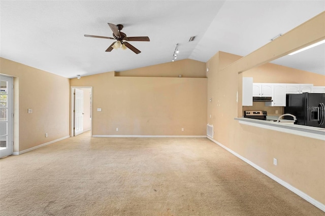 unfurnished living room with track lighting, sink, vaulted ceiling, ceiling fan, and light colored carpet