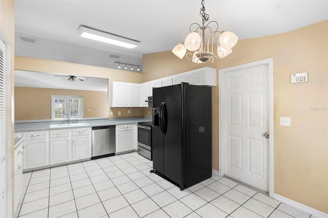 kitchen featuring ceiling fan with notable chandelier, hanging light fixtures, appliances with stainless steel finishes, light tile patterned flooring, and white cabinetry