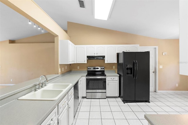 kitchen with lofted ceiling, white cabinets, sink, light tile patterned floors, and stainless steel appliances