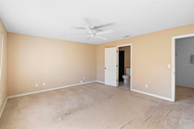 unfurnished bedroom featuring connected bathroom, ceiling fan, and light colored carpet