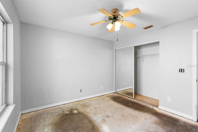 unfurnished bedroom with ceiling fan, a closet, and concrete flooring