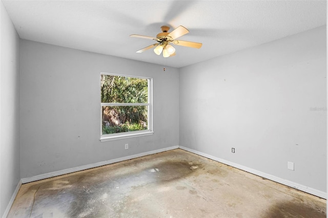 empty room featuring ceiling fan and concrete flooring