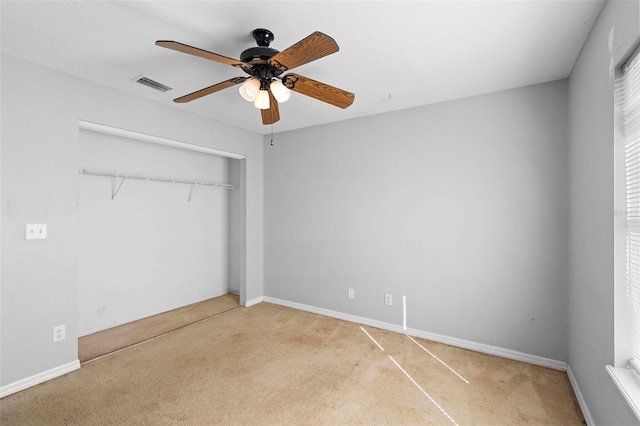 unfurnished bedroom with ceiling fan, a closet, and light carpet