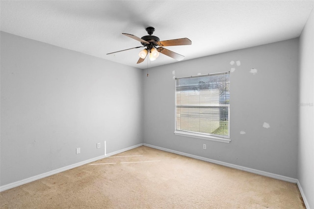 unfurnished room with carpet flooring and ceiling fan