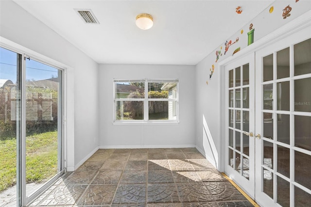 unfurnished sunroom featuring french doors