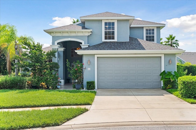 view of front facade with a front yard and a garage