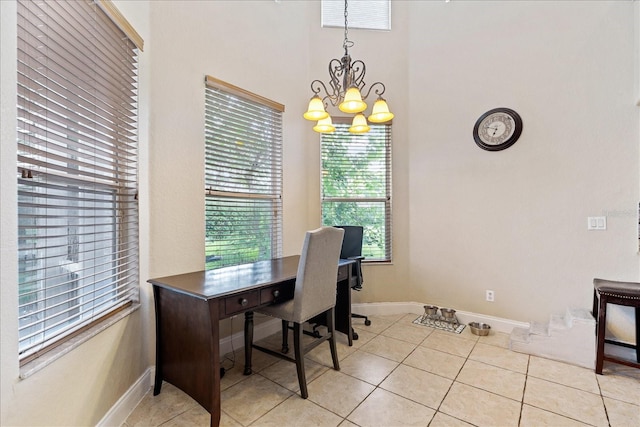 tiled home office with a chandelier