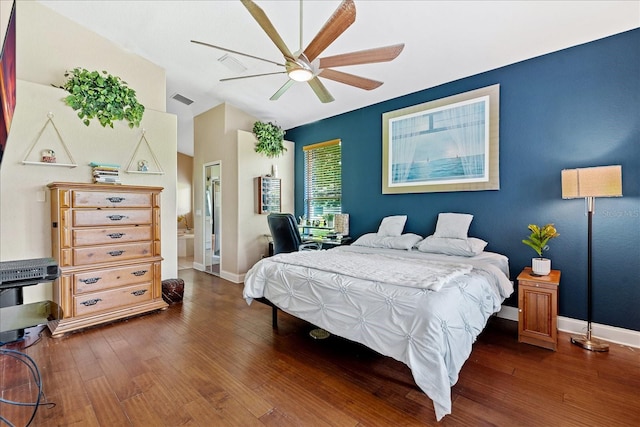 bedroom with ceiling fan, dark hardwood / wood-style flooring, lofted ceiling, and connected bathroom