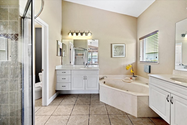 full bathroom with shower with separate bathtub, vanity, toilet, and tile patterned floors