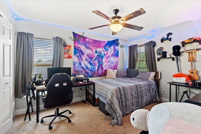 bedroom with ceiling fan and light colored carpet