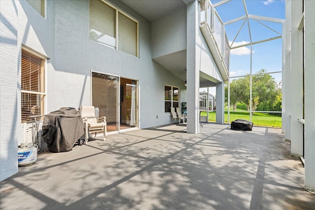 view of patio / terrace with glass enclosure and ceiling fan