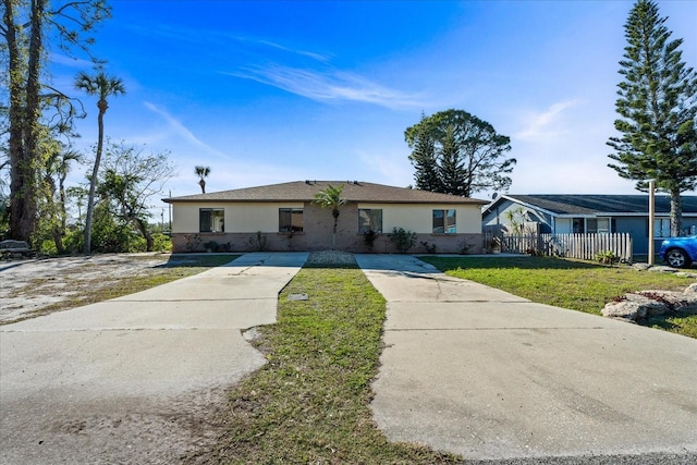 ranch-style home with a front lawn