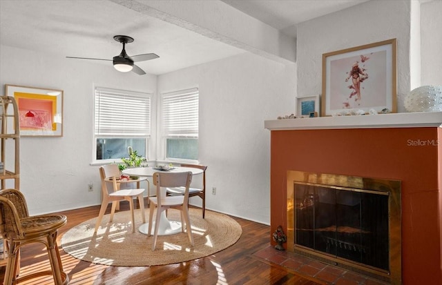 dining area featuring ceiling fan and dark wood-type flooring