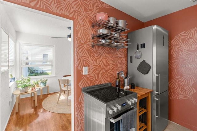 kitchen with wood counters, ceiling fan, wood-type flooring, and stainless steel appliances