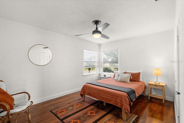 bedroom with ceiling fan and dark hardwood / wood-style flooring