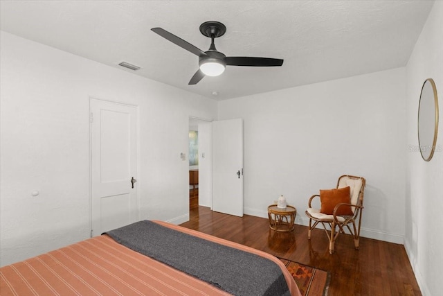 bedroom with ceiling fan and dark hardwood / wood-style floors