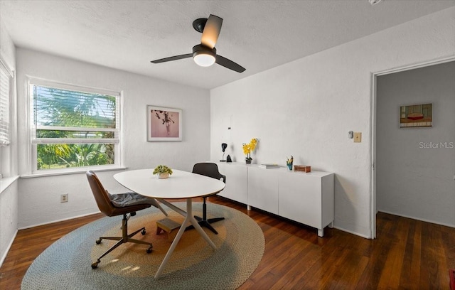 dining area featuring ceiling fan and dark hardwood / wood-style flooring