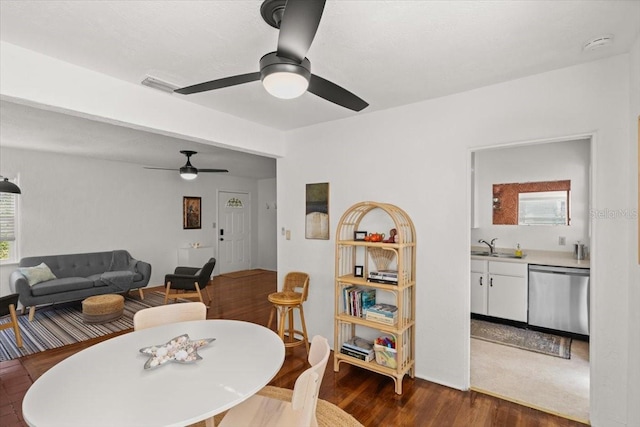 dining room with ceiling fan, dark hardwood / wood-style flooring, and sink