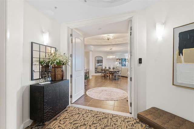 entrance foyer featuring tile patterned flooring and a chandelier