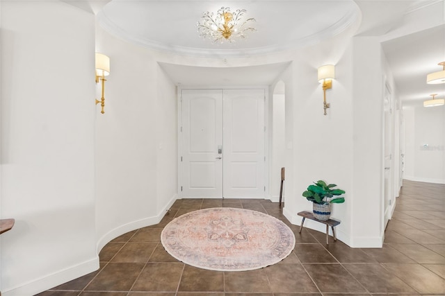 tiled entryway with an inviting chandelier